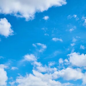 A blue sky with white clouds in the background representing Brionglóid Álainn.